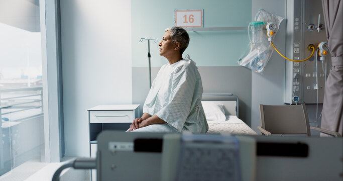Sad, patient and thinking in hospital with window and stress, anxiety or fear of cancer, death and insurance. Senior, woman and depression in clinic with lady worried for future or mental health