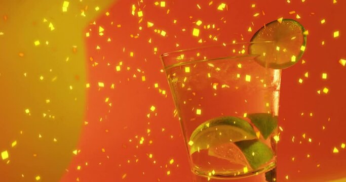 Animation of confetti falling and cocktail on red background