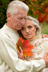 Portrait of sad senior couple in autumn park