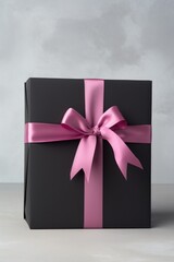 Black gift box with ribbon bow.