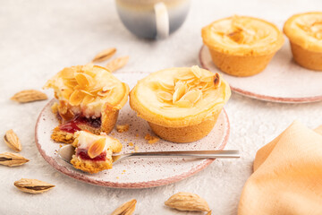 Traditional portuguese cakes pasteis de nata, custard small pies on gray concrete. Side view, selective focus.