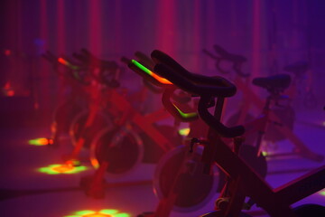 Bike trainer in the fitness center with disco lights