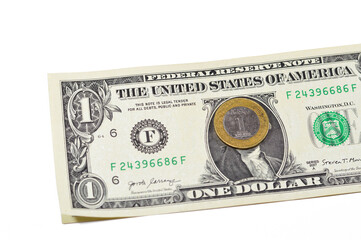 One Saudi Arabia riyal coin year 2016 on 1 American dollar USD paper banknote background, one metal...