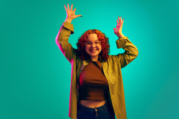 Teen girl in casual clothes standing with emotional face, expressing happiness and shock against...