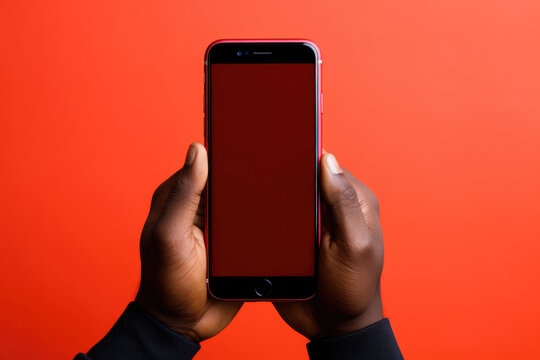 African Person Holding Smartphone, Red Background