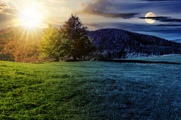 . mountain autumn landscape with sun and moon at twilight. trees on hillside meadow. day and night time change concept. mysterious countryside scenery in morning light