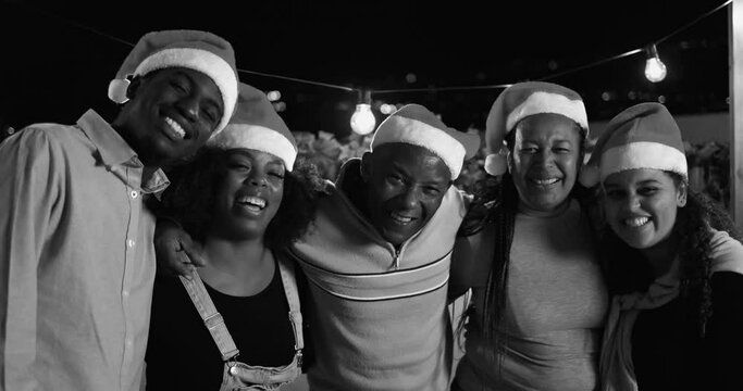 Happy african family having fun hugging each other and celebrating Christmas eve together - Holiday concept - Black and white editing 