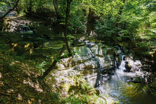 small water stream among boulders. tranquil nature landscape in the woods