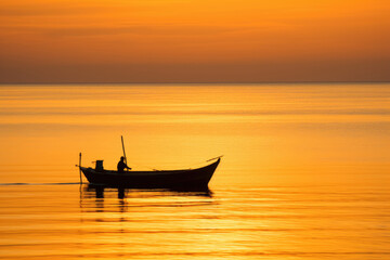 Serene Silhouette: Boat on a Golden Sea