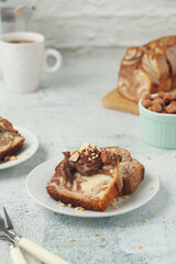 A piece of marble biscuit with chocolate cream and nuts