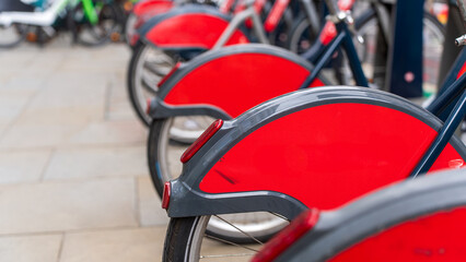 Red city bikes lined up ready for use