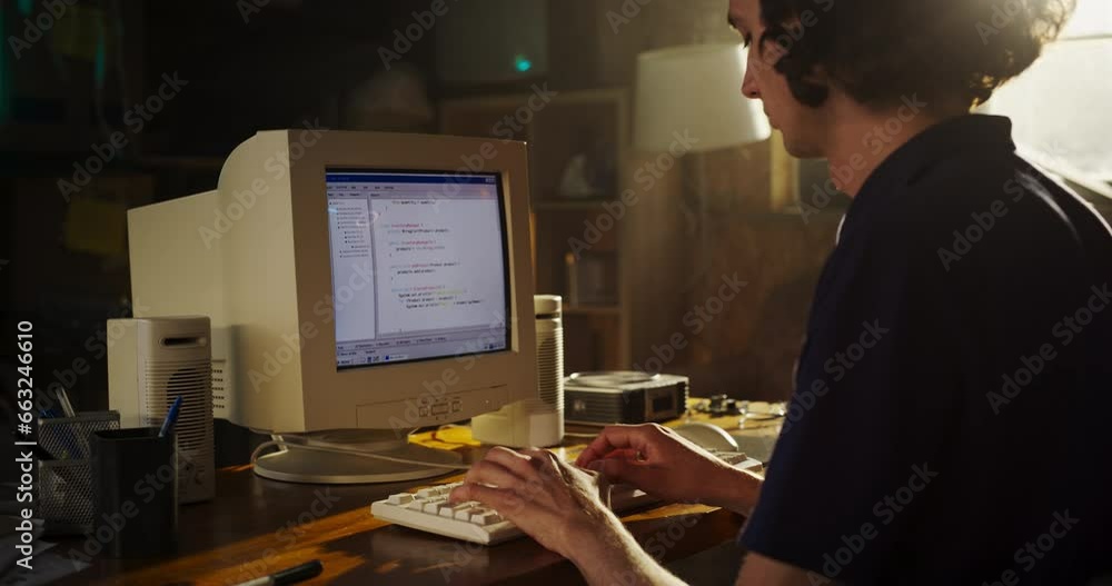 Fototapete zoom out shot: caucasian male software engineer programming on old desktop computer in retro garage.