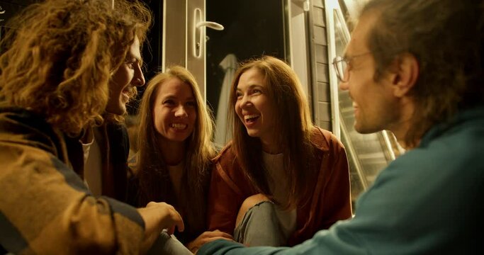 two girls and two boys are having fun. Rest in the country house
