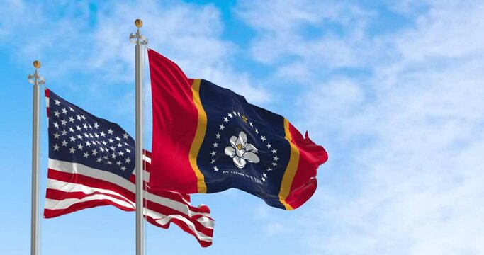 Mississippi state flag waving with the American flag on a clear day