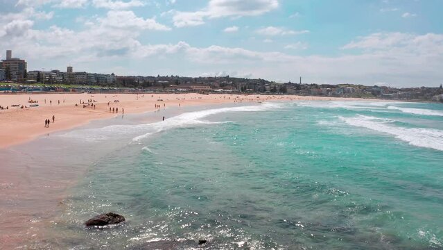 Bondi beach Australia. Sunny Sydney coast with people relaxing on seashore