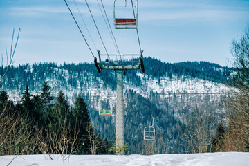 Winter landscape with rope tow to the top of the mountain. View  of elevator with snow-covered...