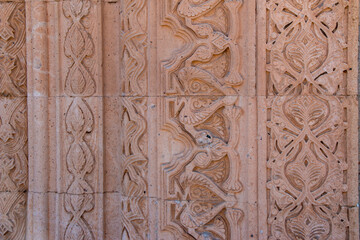 Close-up view of the outer stones of the historical Esrefoglu Mosque. Handcrafted ornament of Esrefoglu Mosque. Konya, Turkey.