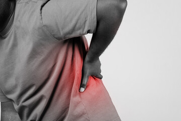 African guy touching aching lower back with pain spot, cropped