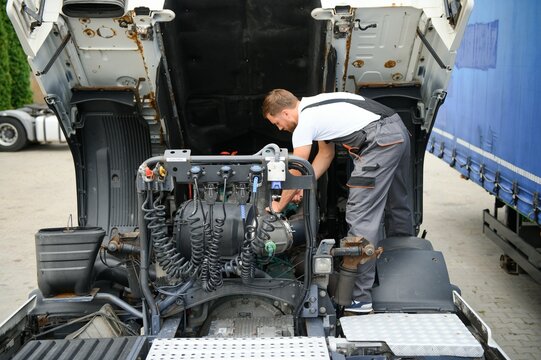 Professional truck mechanic working in vehicle repair service.