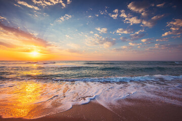 Ocean sunrise over the tropical sea shore and exotic island beach