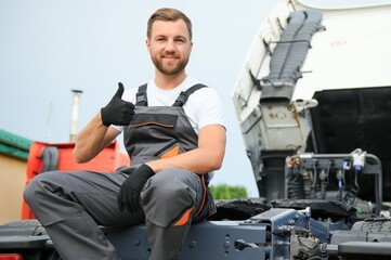 Man in uniform. Truck repair. Car malfunction