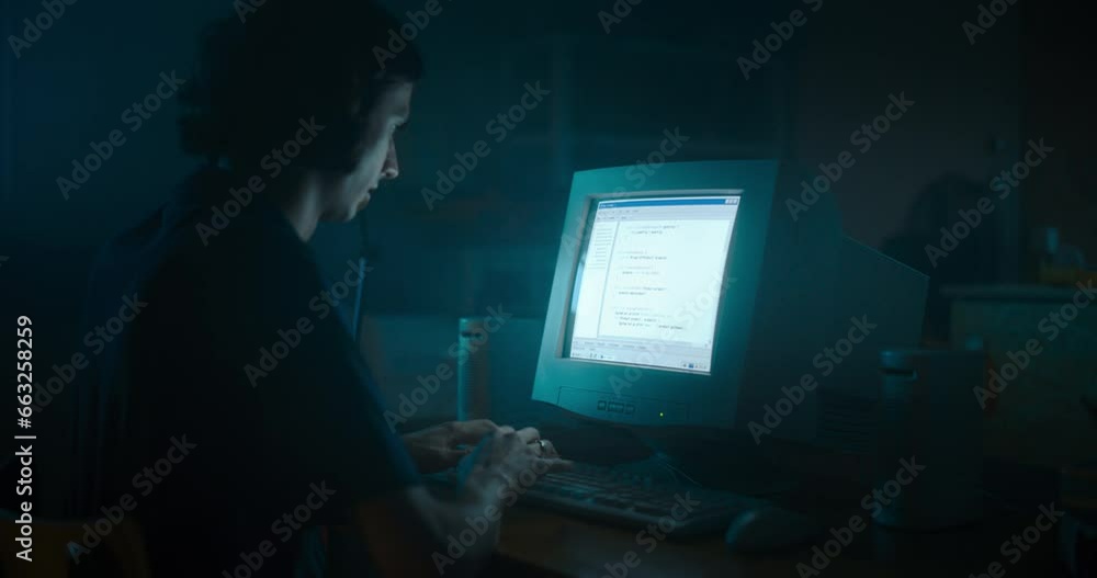 Poster Caucasian Male Web Designer Using Old Desktop Computer In Retro Garage Late At Night. Focused Internet Enthusiast Writing Code At Home. Programming Successful Social Network Website In Nineties.