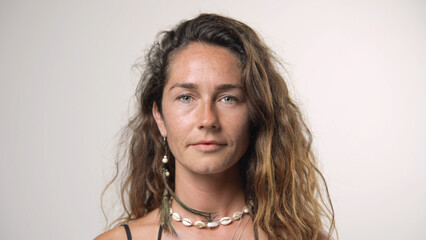 Beautiful person look at camera close up. Young adult woman face portrait. Stylish 30 years old girl on isolated white background. Attractive female feminism model. Modern millennial feminist people.