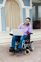 talking on the phone to a special person with disabilities with a laptop