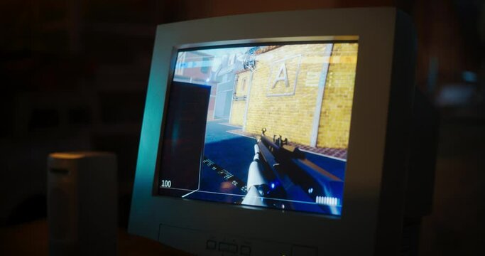 Close Up Of Old Desktop Computer With 3D First-Person Shooter Video Game In Retro Garage Late At Night In Nineties. Dated PC Of Gamer Running Popular Game With Character Playing Against Enemies.