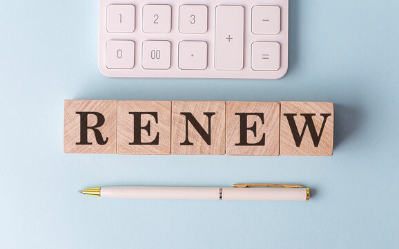 RENEW on wooden cubes with pen and calculator, financial concept