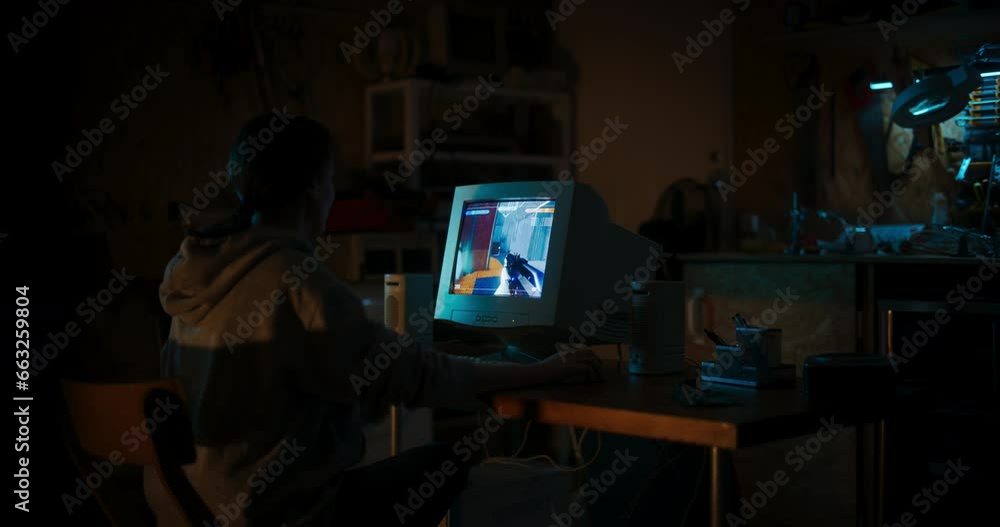 Poster Back View Of Caucasian Female Gamer Playing First Person Shooter Video Game On Old Desktop Computer In Retro Garage Late At Night. Focused Woman Enjoying Competitive Gaming In Nostalgic Nineties.
