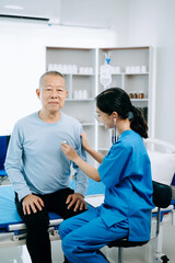 Obraz premium Friendly Female Head Nurse Making Rounds does Checkup on Patient Resting in Bed. She Checks tablet while Man Fully Recovering after Successful Surgery in hospital.