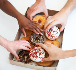 Donut, box and hands of people with delivery of food in office, meeting or white background in...