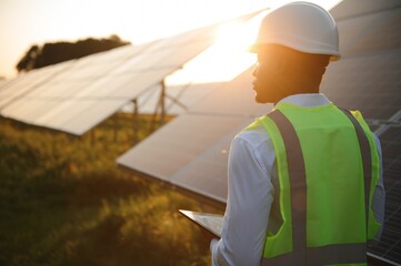 African american technician check the maintenance of the solar panels. Black man engineer at solar...