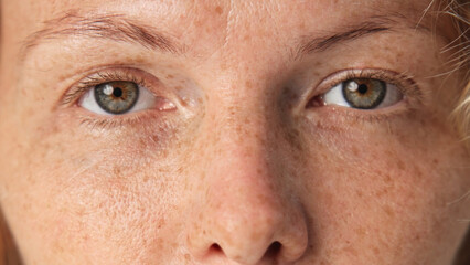 Beautiful person look at camera close up. Young adult woman face portrait. Stylish 30 years old girl on isolated white background. Attractive female feminism model. Modern millennial feminist people.