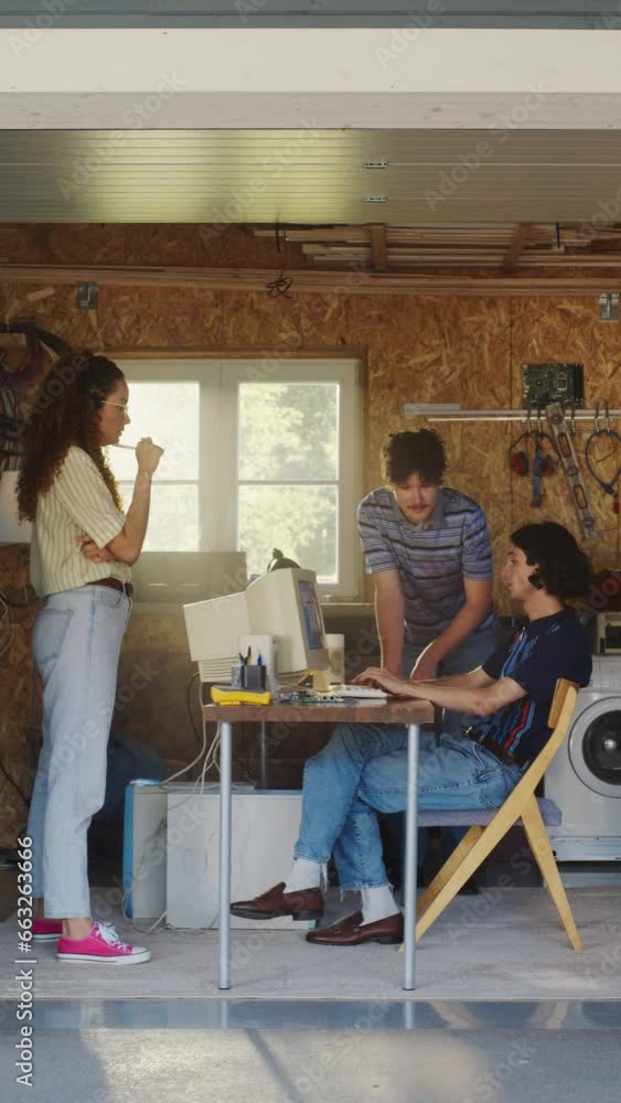 Poster vertical screen: diverse team of three young tech startup company founders working in retro garage, 