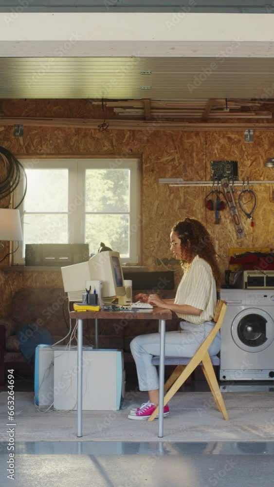Poster Vertical Screen: Hispanic Female Developer Programming On Old Desktop Computer In Retro Garage With Random Appliances. Young Woman Working On Innovative Online Service Startup Company In Nineties.
