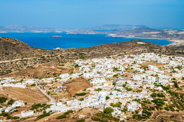 View of Plaka village with white houses and sea view from high vantage point, Milos island,...