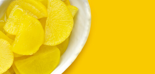 Sweet and tart slices of yellow pickled daikon, known as takuan in Japan and danmuji in Korea.