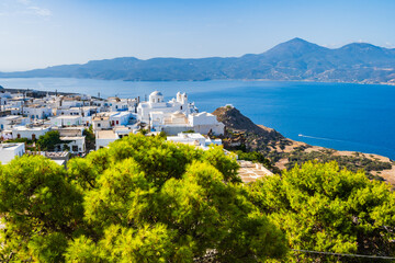View of Plaka village with white houses and sea view from high vantage point, Milos island,...