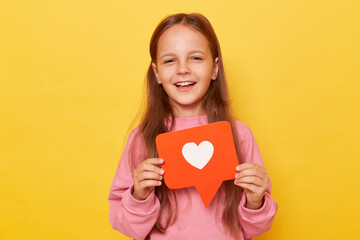 Blogging icon. Like button. Viral blog. Digital love. Share content. Smiling little girl wearing pink sweatshirt posing isolated over yellow background.