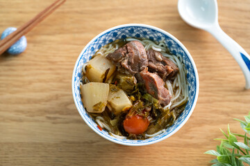 Beef noodle soup. Taiwanese famous food in a bowl on wooden table.