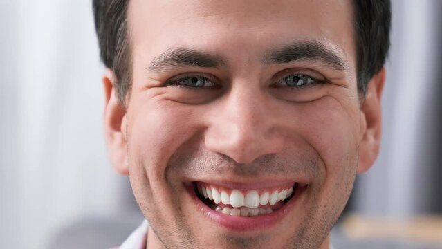 Happy perfect white teeth smile close up. American dental service clinic. Nice person laugh. Fun young adult man. Joy male guy face closeup. Oral tooth whitening stomatology. Dentistry hygiene care.