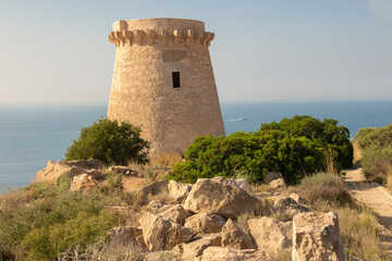 Fototapeta na wymiar Provincia de Alicante - Santa Pola - Torres Vigía en el litoral de la Comunidad Valenciana: La Torre del Tamarit y la Torre Escarletes