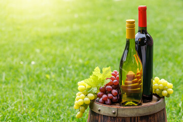 Fototapeta premium Wine bottles and grape on barrel