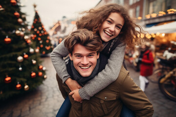 happy smiling portrait of a couple wearing warm clothes in Christmas market