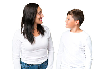 Little caucasian kid over isolated chroma key background looking at each other