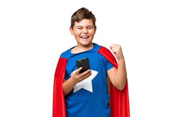 Super Hero caucasian kid over isolated chroma key background with phone in victory position