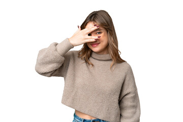 Young girl over isolated chroma key background covering eyes by hands and smiling
