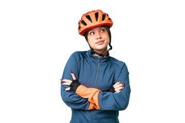 Young cyclist girl over isolated chroma key background making doubts gesture while lifting the shoulders